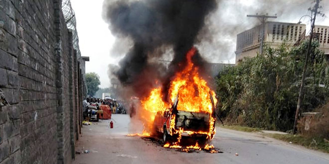 A burning vehicle near the attack site in Karachi